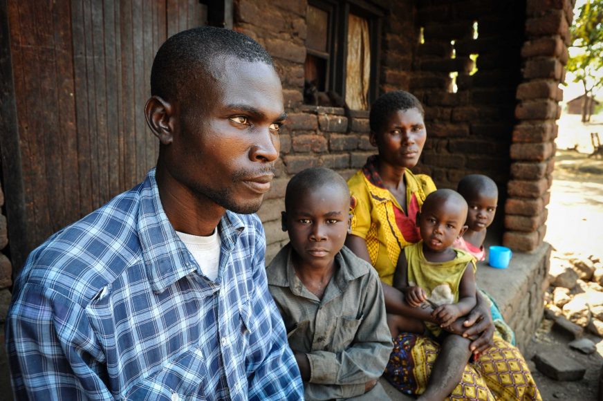Rute Fumulani is 16 years old and lives in the village of Kachaso, Nsanje district, Malawi. She lost both her parents in catastrophic flooding that hit the area in 2015. She married husband Fumulani in the same year at the age of 14: the couple have a son, Thokozani, aged one year and two months. They live in a two room hut with her husband's nine year old brother, Eliya, and five year old sister, Amines. They earn a maximum of MWK 500 (about 50p) on days they can find work and eat only on three days a week. L-R: Fumulani, Eliya, Rute, Thokozani, Amines