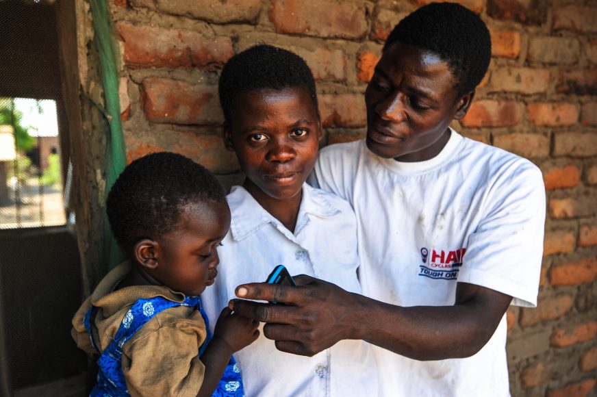 Charity Lloyd, 19. She got married at the age of 17 after her mother died during heavy flooding in the Nsanje district of Malawi, an event blamed by some experts on changing climate. Her father had died a few years earlier. She lives in Malakeza village in the Nsanje district of Malawi. Pictured with her husband Isaac Chuva, 23 and their daughter Eveless, one and a half years old.